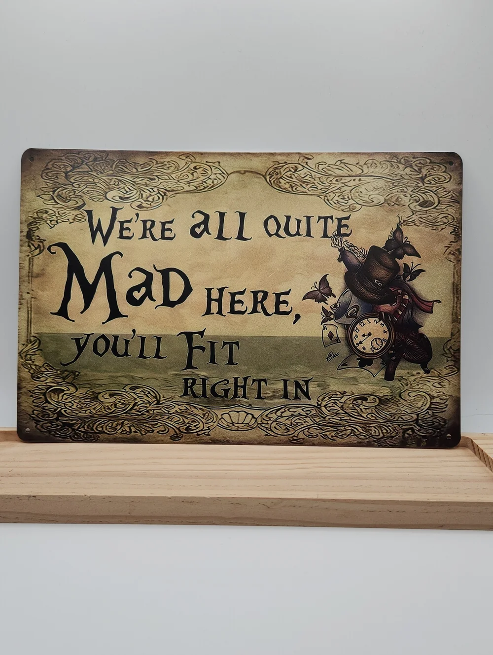 Alice-Inspired 'We're All Quite Mad Here' Metal Sign - Beige & Olive